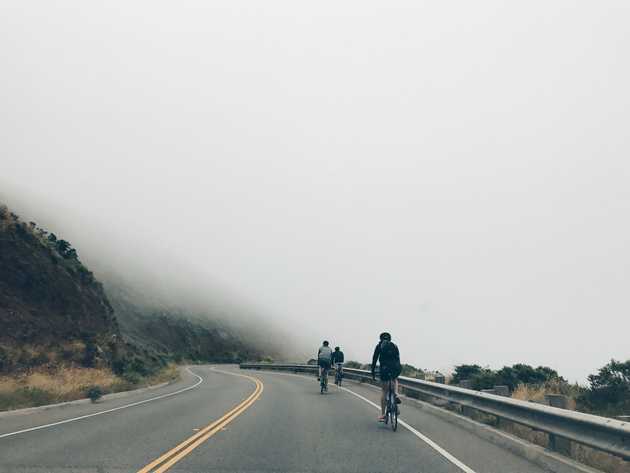 Cyclists riding in fog