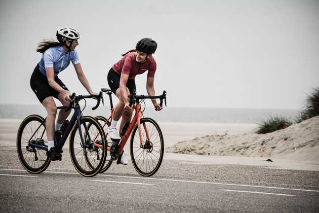 A pair of cyclists riding together